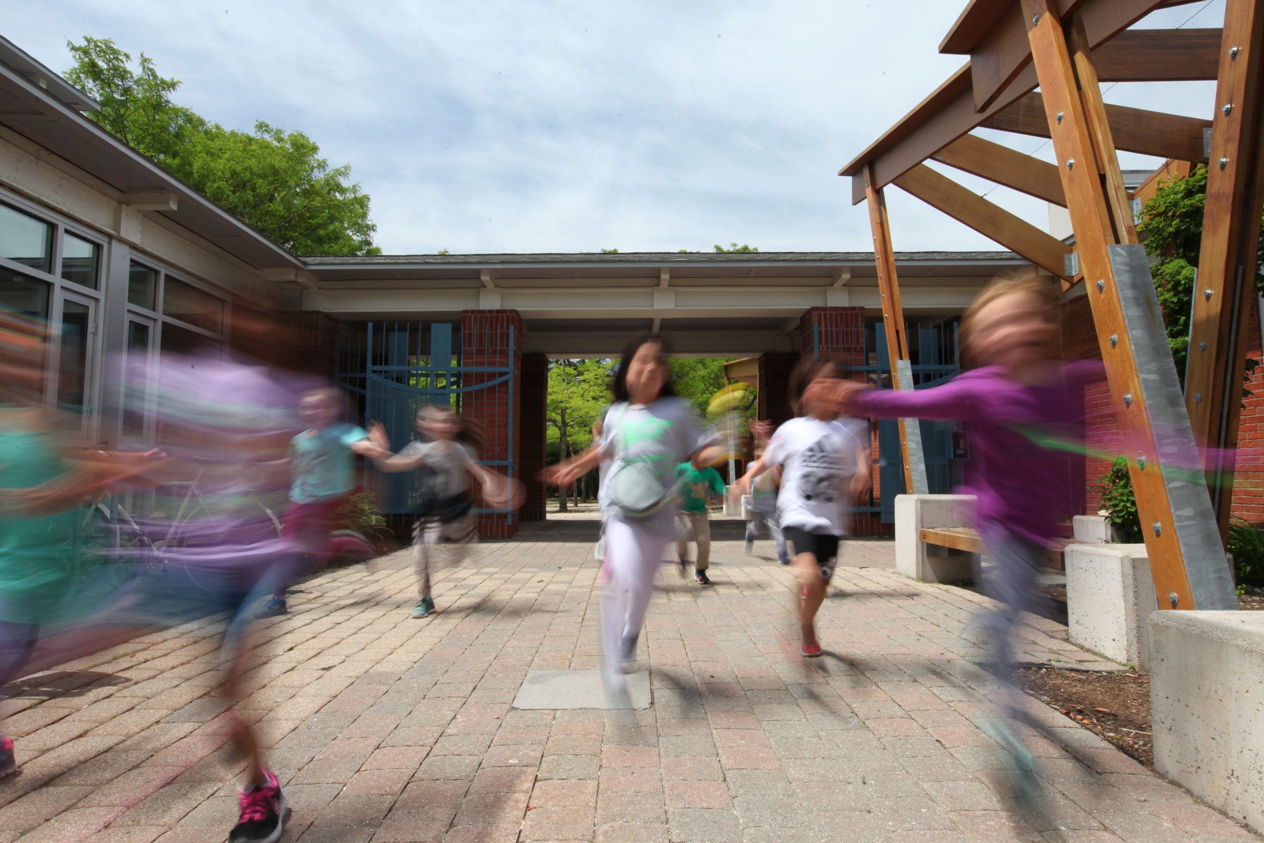 Students running at outside entrance of Cambridge Friends School