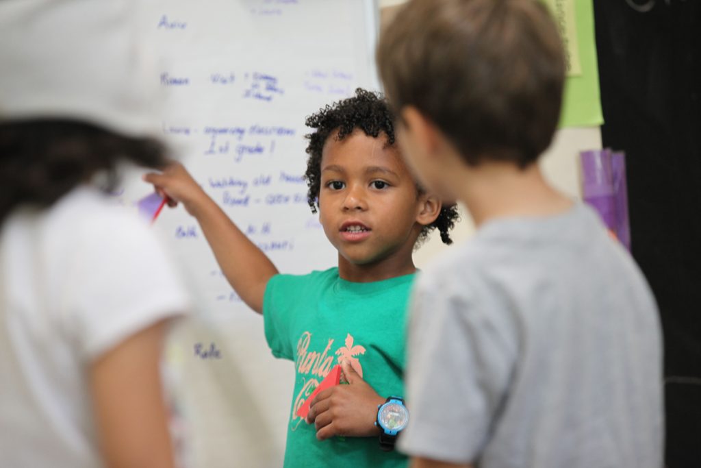 Pre-K-Student-working-at-white-board