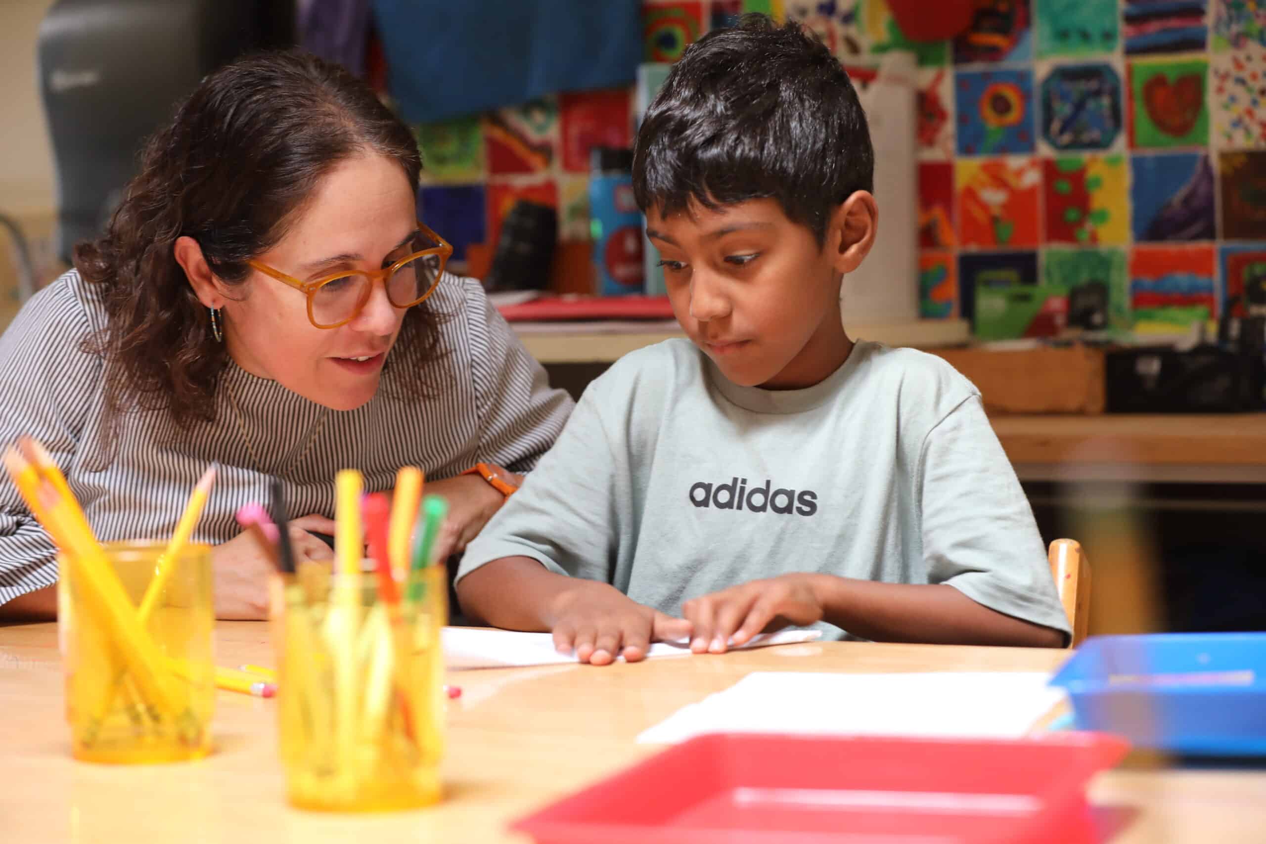 teacher working with a student